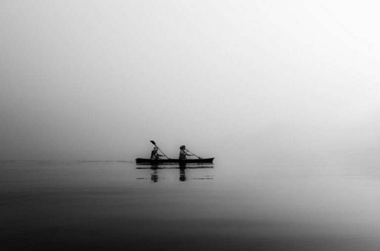 Rowing - two person sailing on calm body of water