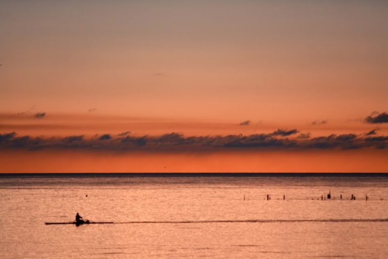 Rowing - person kayaking during sunset