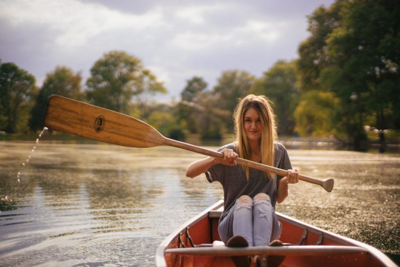 Rowing Boat - woman sitting in brown paddle boat
