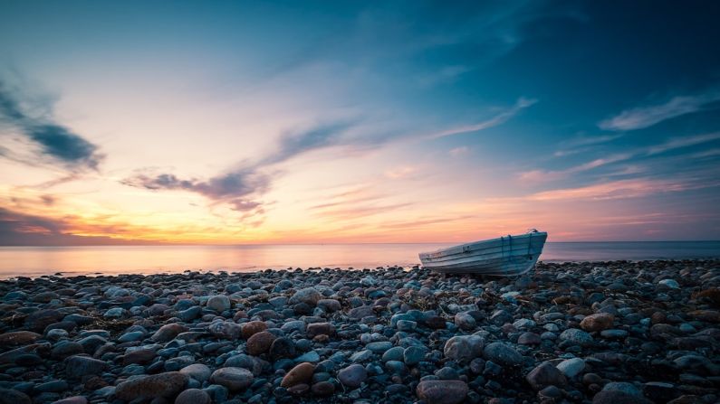 Rowing Boat - white boat on sea shore during sunset