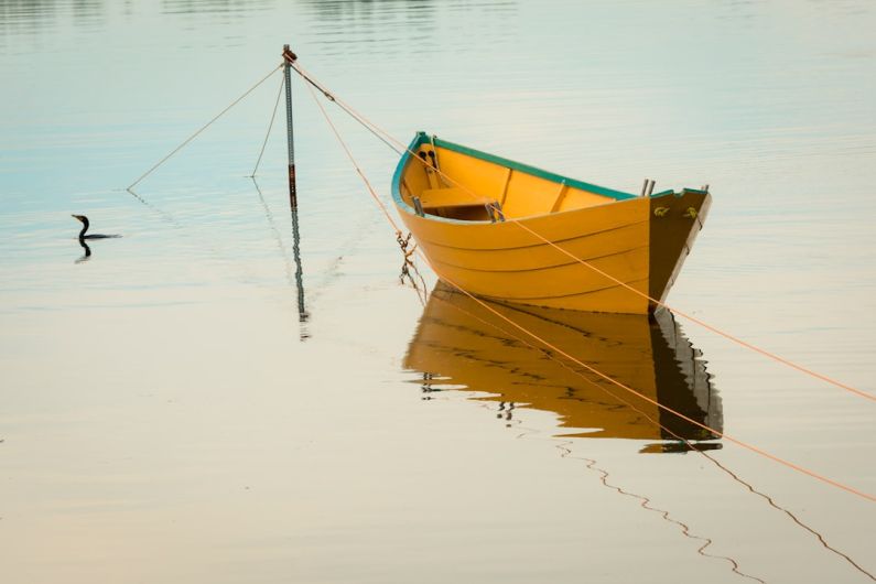 Rowing Boat - yellow canoe on body of water