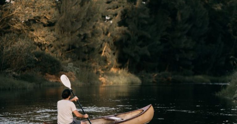 Rowing - A Man Kayaking Near Trees