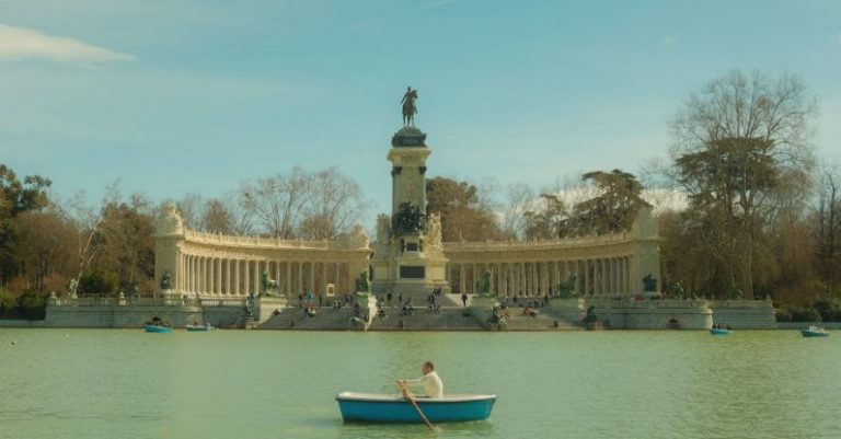 Rowing - Man Rowing Boat under Monument to Alfonso XII in Madrid, Spain