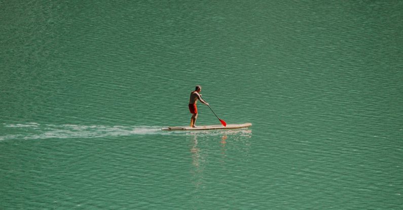 Rowing - Man on Canoe in Water