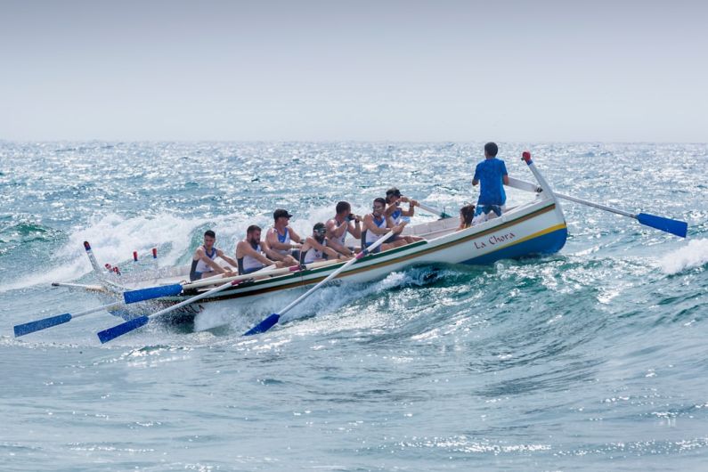 Rowing - group of men riding boat